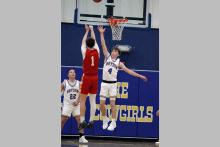 Bryce Thorne jumps in the air to defend a shot Tuesday, Nov. 18 against Christ Academy. The Cowboys lost to the Warriors in their matchup 55-35. Photo/Ashley Anderson