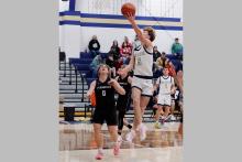 Case Lambert puts up a layup Friday, Dec. 19 against the Lingleville Cardinals. Lambert scored 20 points in the blowout win over the Cardinals 69-24. Photo/Ashley Anderson