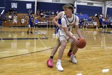 Wiett Newton looks to pass the ball Monday, Nov. 24 against the Prairie Valley Bulldogs. The Cowboys won their final game before the Thanksgiving break 48-46 over the Bulldogs. Photo/Ashley Anderson